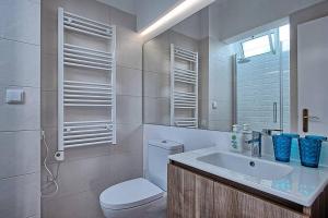 a white bathroom with a toilet and a sink at Graça 4 in Lisbon +20 photos