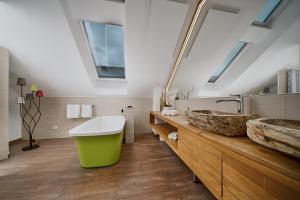 a bathroom with two sinks and a large mirror at Villa Salzburg by Welcome to Salzburg in Salzburg +66 photos