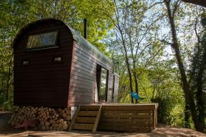 a tiny house on a pile of logs at Extraordinary Huts Ltd in Rye
