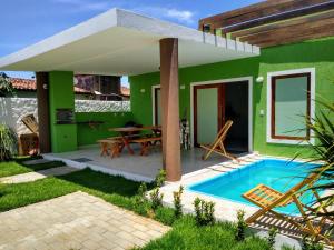 a green house with a swimming pool and a patio at GREEN HOUSE in Pipa