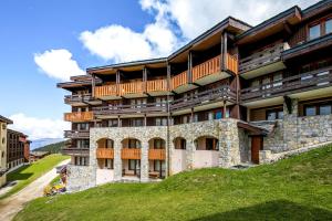 Un edificio de apartamentos con balcones en una colina. en Résidence Pierre & Vacances Les Constellations, en Belle Plagne