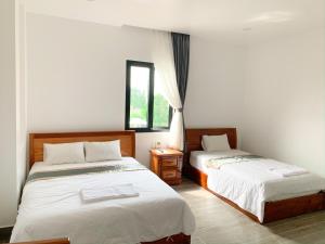 Un ou plusieurs lits dans un hébergement de l'établissement Hotel Thiện Nhiên