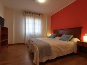 a bedroom with a large bed and a window at Hotel El Trasgu in Cangas de Onís