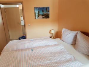 a bedroom with a bed with two pillows at Kleine gemütliche Ferienwohnung in Dresden