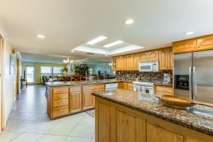 a large kitchen with wooden cabinets and stainless steel appliances at Saida Towers IV #4906 in South Padre Island