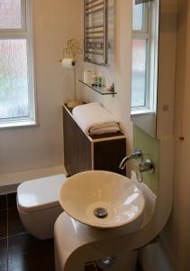 a bathroom with a white toilet and a sink at The Bell in Shifnal