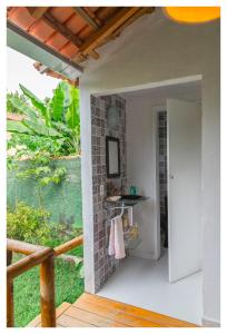 an open door to a patio with a table at Pousada Cravo e Canela in Arraial d'Ajuda