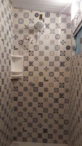 a bathroom with alot of tiles on the wall at Hostel Meu Sossego Vilas in Lauro de Freitas +33 photos