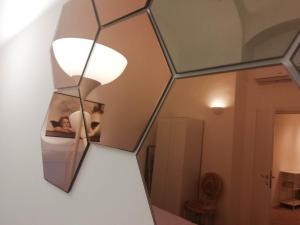 a mirror hanging on a wall in a room at MistrangeloHome 3 - Appartamento in Pieno Centro in Savona +36 photos