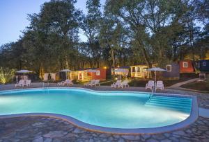 a swimming pool with a group of tents in the background at Aminess Maravea Camping Resort Mobile Homes in Novigrad Istria