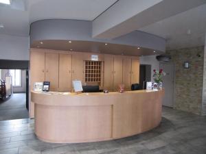 un hall avec un comptoir de réception dans un bâtiment dans l'établissement Contact Hotel de France, à Saintes