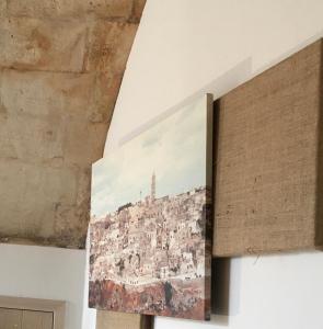 a painting of a city on a wall at B&B La Corte in Matera