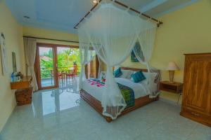 Postel nebo postele na pokoji v ubytování Tantra House Ubud