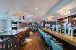 a restaurant with a bar and a large window at McWilliam Park Hotel in Claremorris