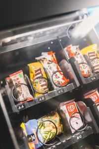 a refrigerator drawer filled with different types of food at Secret Spot Hostel in La Massana