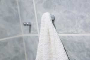 a white shower curtain hanging in a bathroom at Kościuszki OFF Piotrkowska in Łódź +15 photos