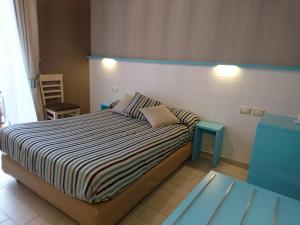 Llit o llits en una habitació de Hotel La Spiaggia