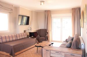 a living room with a bed and a couch at Apartment Achilles in Litochoro