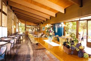 a restaurant with tables and chairs with flowers on them at Sporthotel Olimpo in Garda