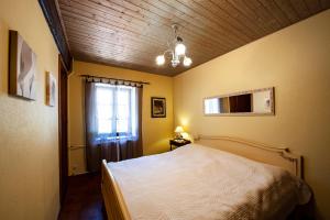 1 dormitorio con cama blanca y ventana en Manoir-de-Sagy, en Sagy