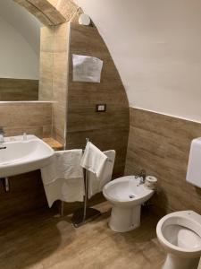 a bathroom with a sink and a toilet at B&B La Dimora in Corato