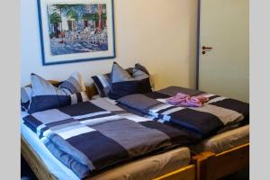 a bedroom with two beds with blue and white at Ferienwohnung Vicus - am Fuße des Schaumberges in Tholey