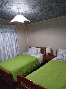 Katil atau katil-katil dalam bilik di Hostal los Almendros de Canela