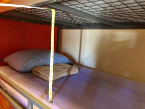 a bunk bed with a pole on top of it at SLC Hostel in Salt Lake City
