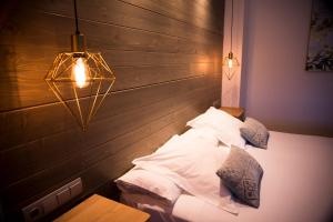 1 dormitorio con cabecero de madera y cama con almohadas en Hotel Sercotel Cuatro Postes, en Ávila