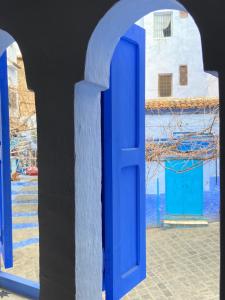 a blue door with a view of the water at Casa Perleta in Chefchaouene