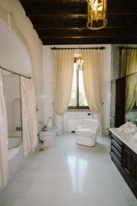 a bathroom with two toilets and two sinks and a tub at La Posta Vecchia Hotel in Ladispoli