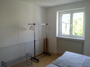 a room with a bed and a lamp and a window at Appartement Feldkirch in Feldkirch