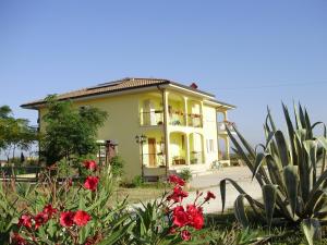 a yellow house with red flowers in front of it at Villa Marianna in Vasto