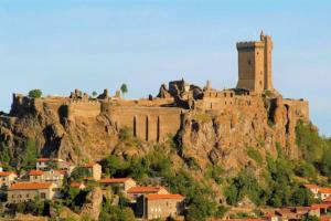 a castle on the side of a mountain with houses at STUDIO 1 personne dans le centre historique in Le Puy-en-Velay +11 photos