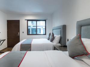 Ένα ή περισσότερα κρεβάτια σε δωμάτιο στο Fraga Hotel Boutique