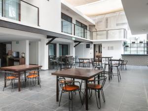a room with tables and chairs in a building at Fraga Hotel Boutique in Irapuato