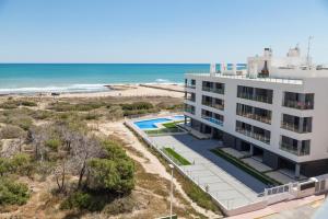 an aerial view of a building next to the beach at Apartament Puerto Romano, La Mata, close to the beach plus parking space in the underground garage in La Mata
