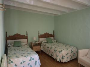 Łóżko lub łóżka w pokoju w obiekcie CASA REHABILITADA SIGLO XVIII
