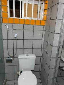 a bathroom with a toilet and a shower at Edf. Iracema Costa in Recife