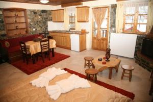 a living room with a table and a kitchen at Guesthouse Sofia in Palaios Agios Athanasios +34 photos