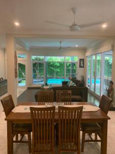 a living room with a wooden table and chairs at Alinta Villa 1 in Sanur