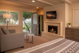 a bedroom with a bed and a fireplace at Carmel Country Inn in Carmel