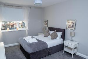 a bedroom with a bed with two towels on it at Luke Stays - Front Street in Newcastle upon Tyne