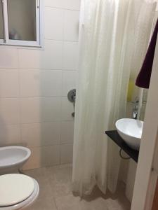 a bathroom with a toilet and a sink at Estudio in Buenos Aires