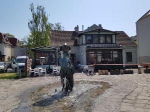 a statue of a woman standing in a fountain at Hostel 19 Sopot in Sopot