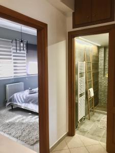 a bedroom with a bed and a glass door at C&C Apartments in Alexandroupoli