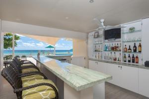a bar with a view of the beach at Rostrevor Hotel in Christ Church