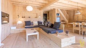 a living room with a blue couch and a table at Le Sancy in Besse-et-Saint-Anastaise