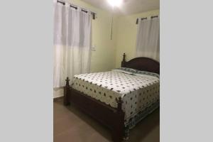 a bedroom with a bed and a window at Standard Private apartment in Tabarre