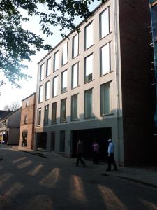 a group of people walking in front of a building at Central, modern and peaceful, lovely Cathedral views, two-bed apartment with 40" smart TV & free onsite parking in Lincoln